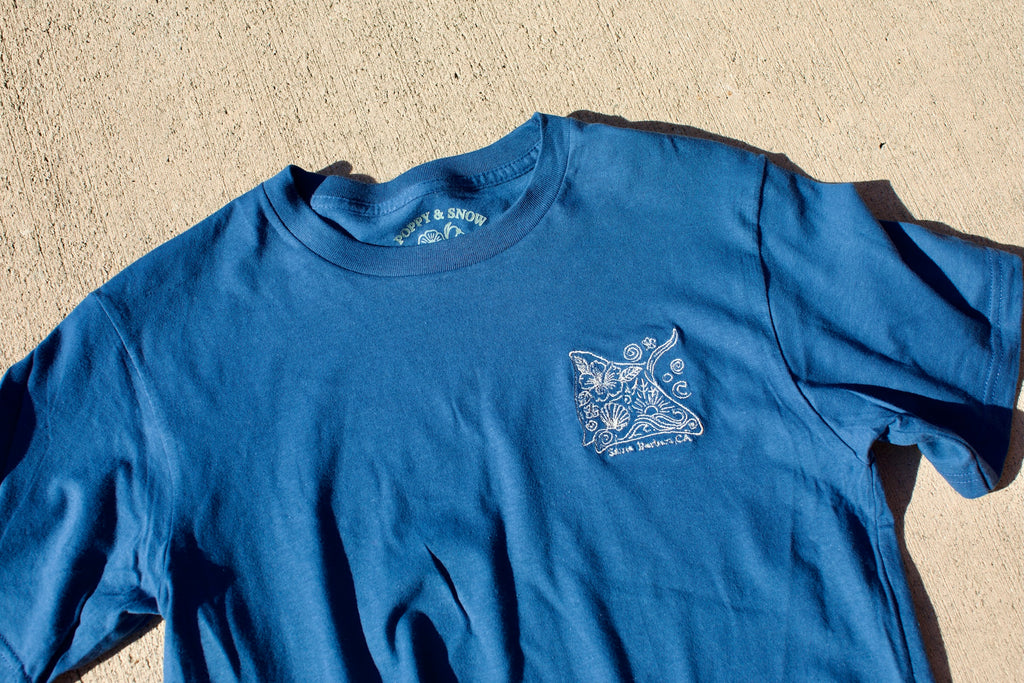 Embroidered stingray design on a navy blue cropped t-shirt with ‘Santa Barbara, CA’ text underneath.