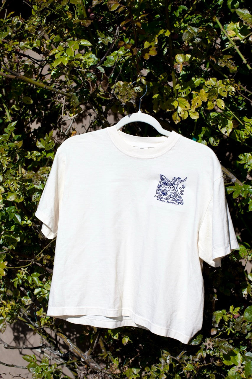 Embroidered stingray design on a cream cropped t-shirt with ‘Santa Barbara, CA’ text underneath.