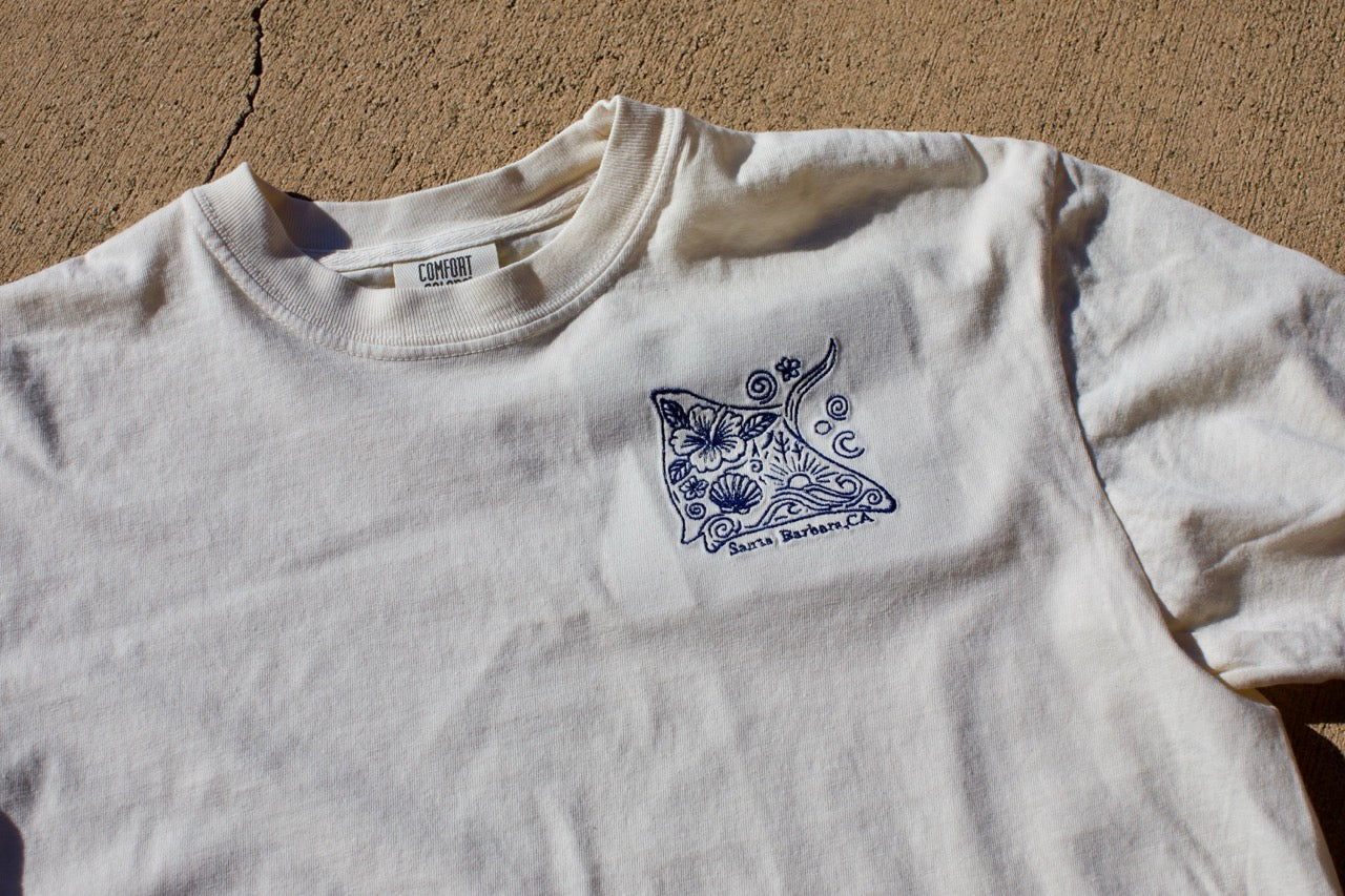Embroidered stingray design on a cream cropped t-shirt with ‘Santa Barbara, CA’ text underneath.