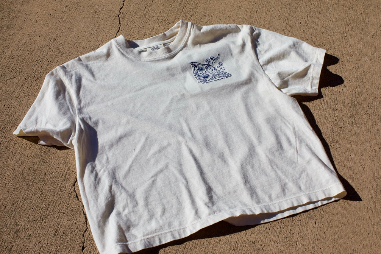 Embroidered stingray design on a cream cropped t-shirt with ‘Santa Barbara, CA’ text underneath.